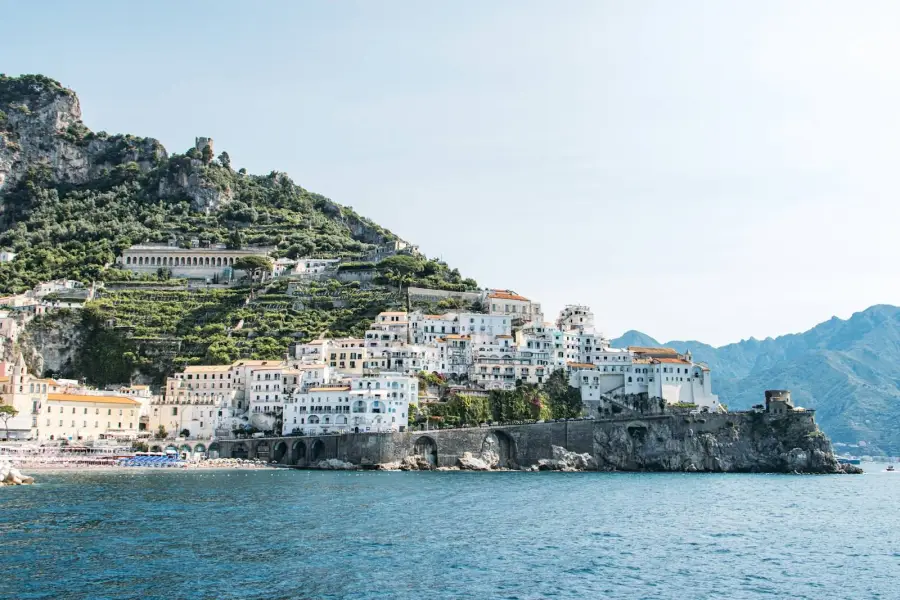 White buildings on a hillside above the sea