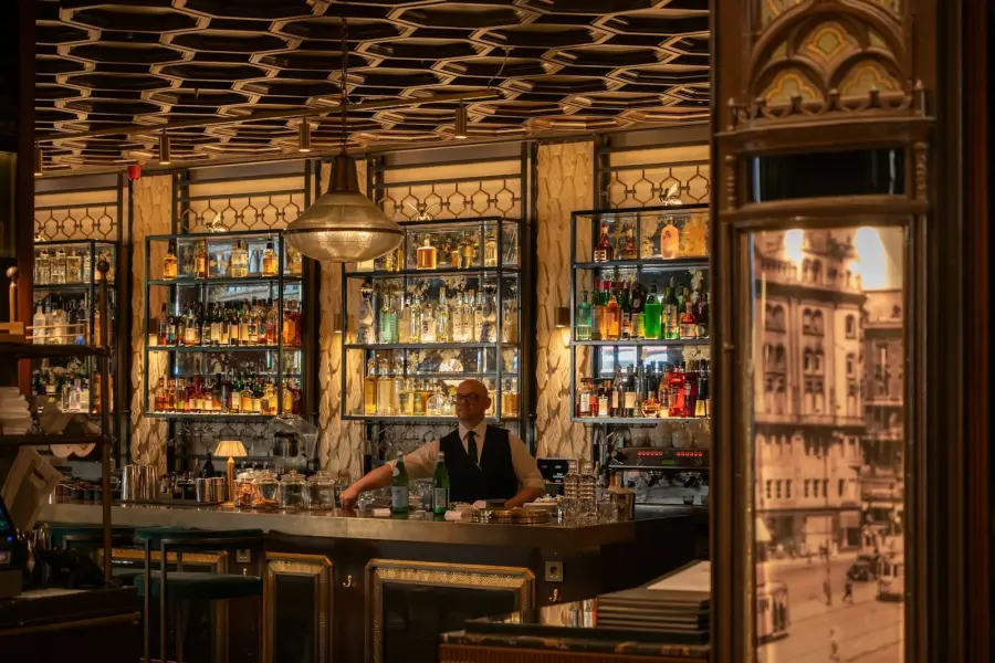 Bartender behind a well-stocked bar