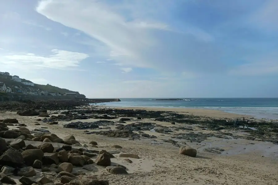 Sandy beach with rocks and houses