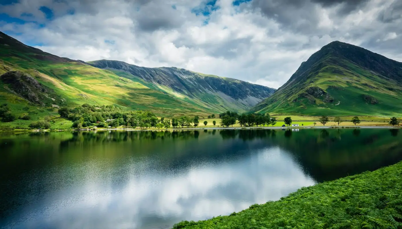 Green mountains beside a lake