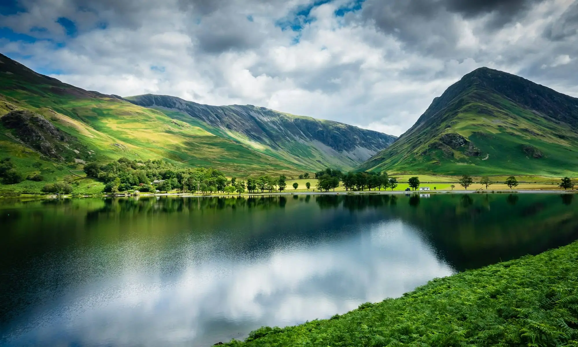 Green mountains beside a lake
