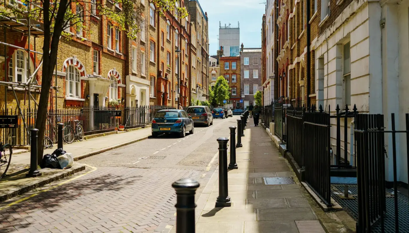 Historic brick buildings line a narrow street