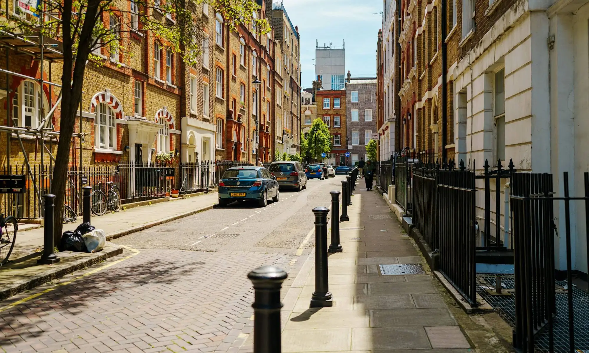 Historic brick buildings line a narrow street
