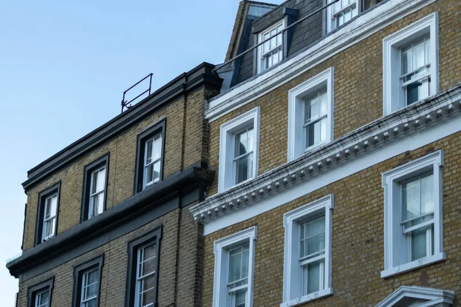 Two brick buildings with many windows