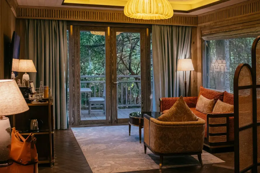 Hotel room with a balcony over trees
